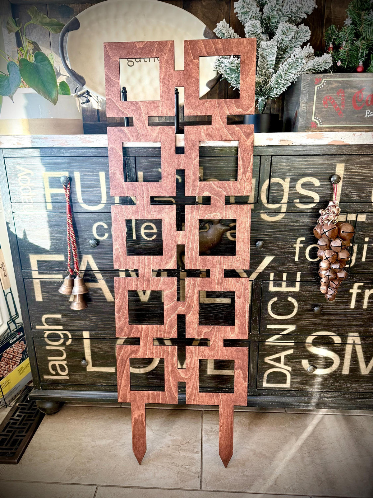 Gunstock Colossal Square Shapes indoor plant trellis displayed upright against a rustic painted wood cabinet
