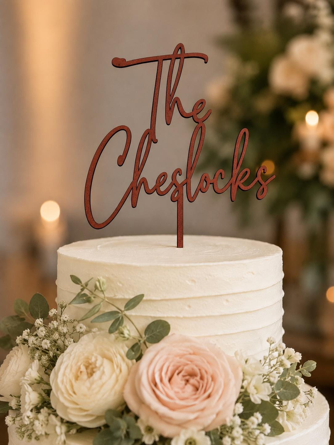 Personalized wood wedding cake topper on a rustic wedding cake with burlap decor