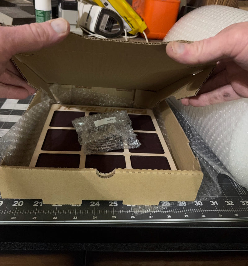 A finished Tic Tac Hockey wood game packed in its shipping box with bubble wrap